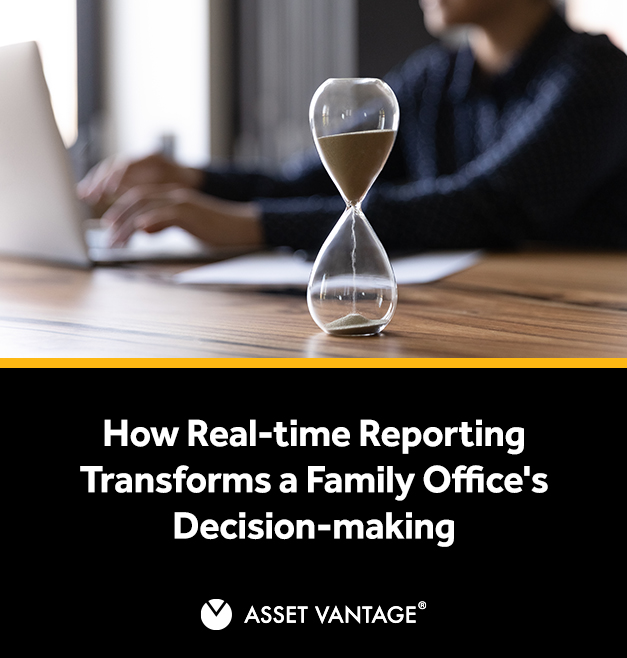 An hourglass on a wooden desk with a person working on a laptop in the background, illustrating the impact of real-time reporting on family office decision-making and efficiency